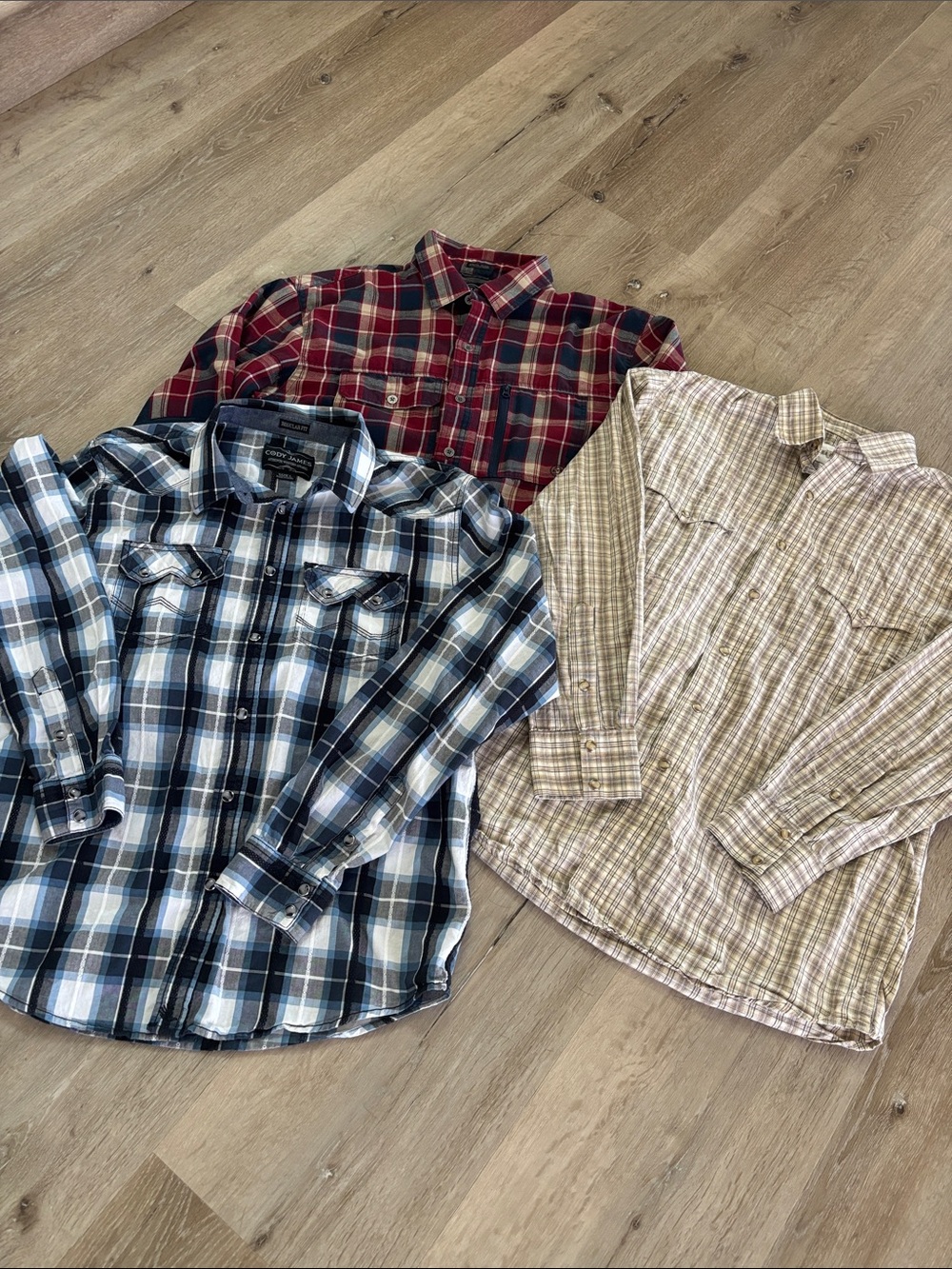 2 Cody James Plaid long sleeve shirts and 1 Wrangler ATG. All size men’s large